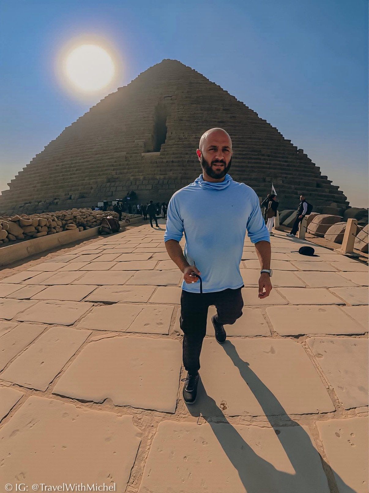 Michel walking the causeway, the Bent Pyramid behind him