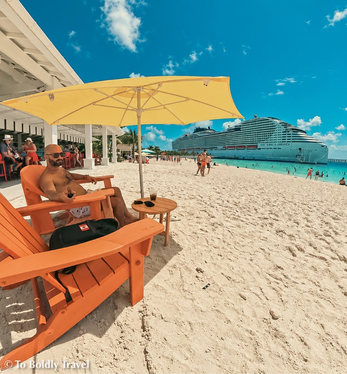 orange Adirondack chairs and yellow umbrella at the beach bar terrace