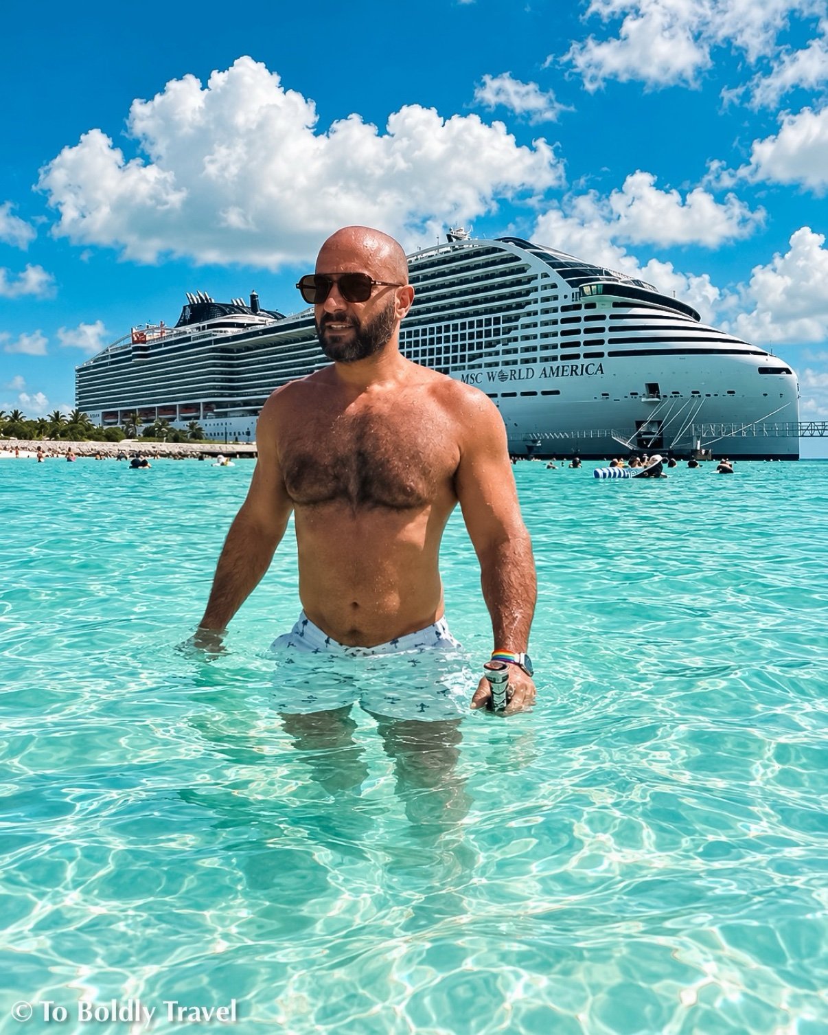 Michel in the lagoon shallows, ship and pier behind