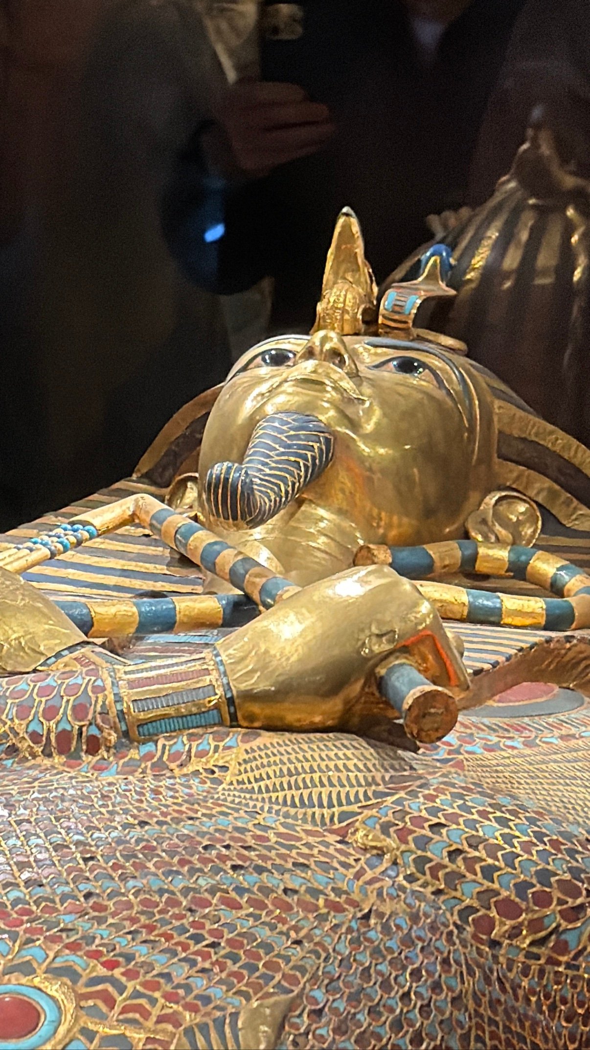 close-up of the golden coffin's face and inlaid headdress