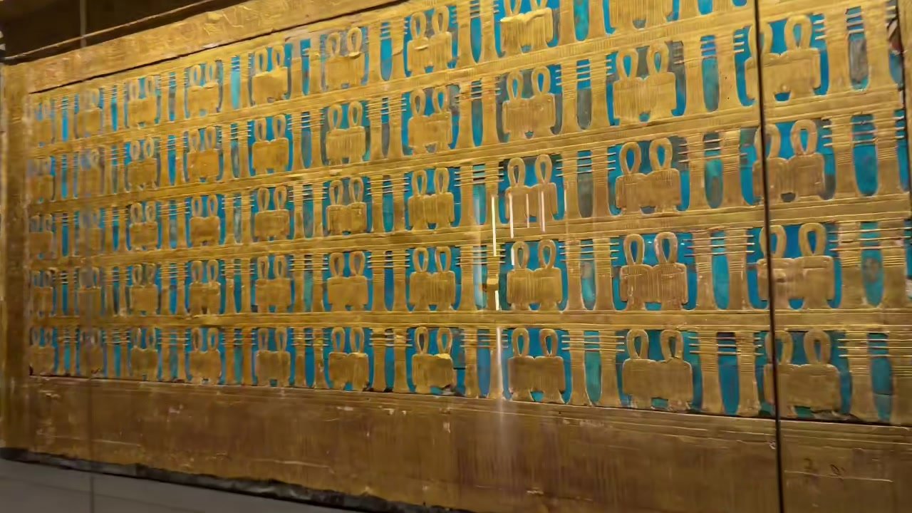 close-up of the shrine's blue-and-gold hieroglyph wall