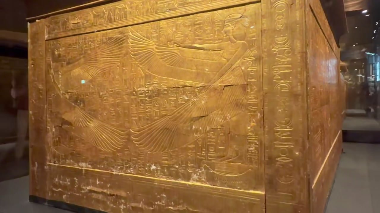the shrine's engraved golden wall with winged goddess relief